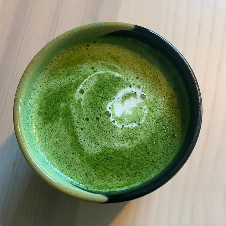 Customer testimonial photo looking down into a bowl of frothy matcha