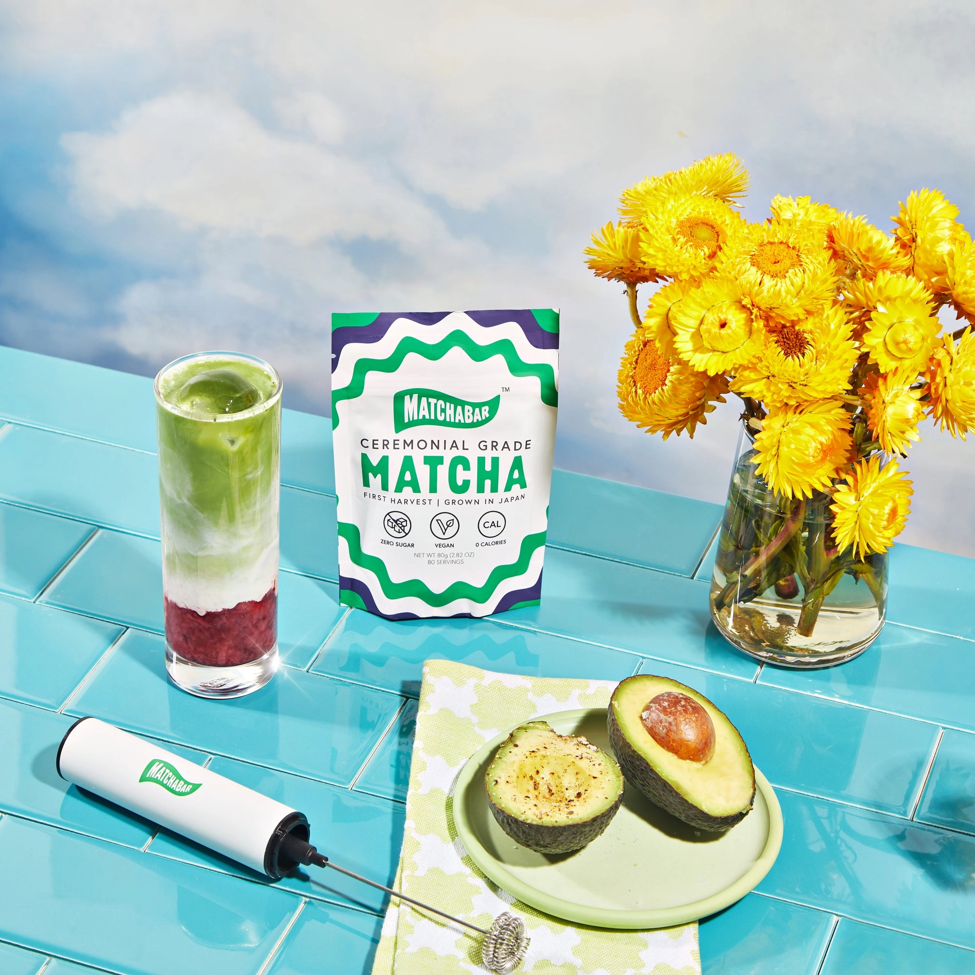 A matcha latte on a counter next to a MatchaBar pouch